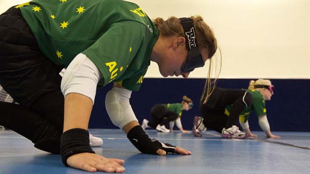 In medal mode ... Australian goalball squad members, from left, Michelle Rzepecki, Tyan Taylor and Jenny Blow train at Trinity Grammar for the Paralympics which start in London on August 29.