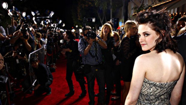 Bizarre and intrusive ... Kristen Stewart intimidated by over-zealous paparazzi.