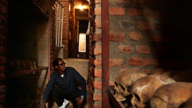 What lies beneath ... Igiraneza Bonus, 20, sits in the crypt under the Nyamata church, where his family was slaughtered in 1994.
