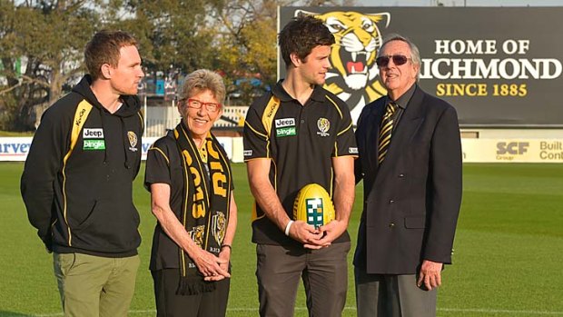 Joan Chapple and Arthur Bonser, members for more than 60 years, join Nathan Foley (left) and Trent Cotchin at Tigerland.