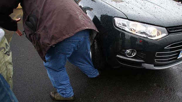 Freelance photographer John Voss's foot is run over by Prime Minister Kevin Rudd's protection team vehicle as they depart the Hobart showgrounds.