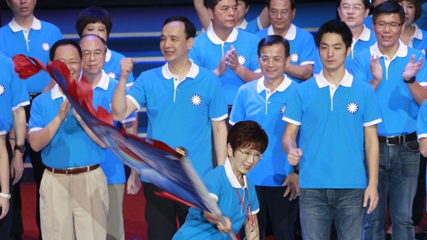 Hung Hsiu-chu, a former teacher and current deputy legislative speaker, waves a flag as she is nominated as the Nationalist party's candidate earlier this month.