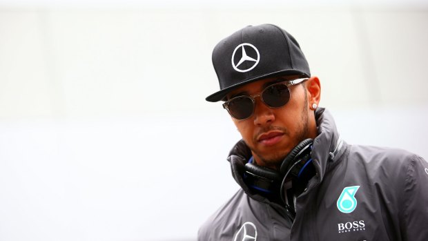 Lewis Hamilton is known for his caps, sunnies and selfies - and that may have landed him in hot water. 