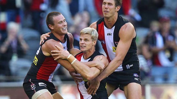 Nick Riewoldt celebrates a goal with David Armitage and Tom Hickey.