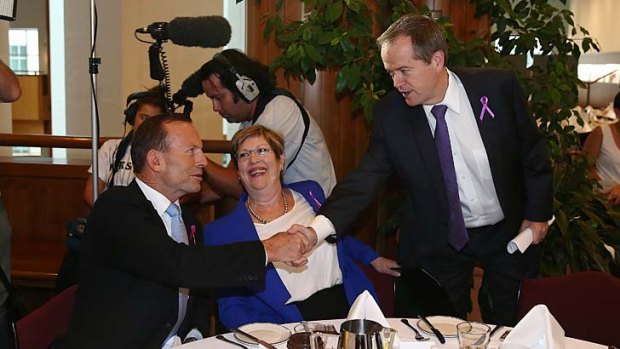 All smiles: Tony Abbott greets Bill Shorten at the Women's Day breakfast.