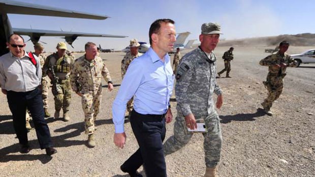 In the war zone: Opposition Leader Tony Abbott is accompanied by Colonel Jim Creighton, commander of Combined Team Uruzgan, who welcomed him to Tarin Kowt.