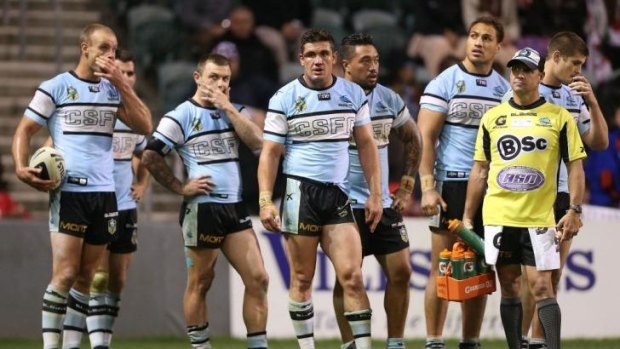 Shellshocked Sharks players in a familiar position last Saturday night, awaiting a Dragons conversion at WIN Stadium.