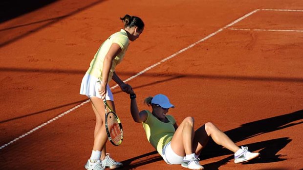 Australia's Jarmila Groth helps up Anastasia Rodionova after she fell.