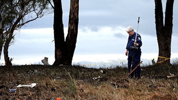 Police inspect the point of impact at the scene of the fatal plane crash north of Bathurst Airport.