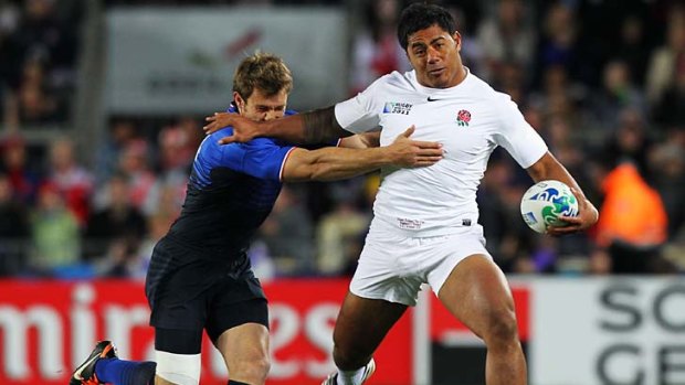 In trouble ... Manu Tuilagi, right, is tackled during England's World Cup quarter-final against France.