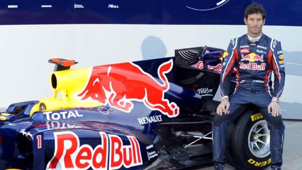 Mark Webber poses next to the new Red Bull RB7 at the Ricardo Tormo racetrack in Valencia, Spain.
