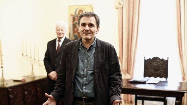 Euclid Tsakalotos, Greece's finance minister, takes a political oath following his appointment at the Presidential Palace in Athens.