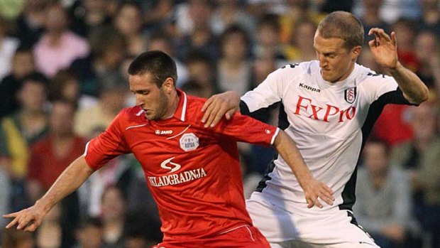 Duje Cop (left) battles for the ball with Brede Hangeland of Fulham.