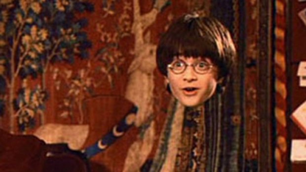 Harry Potter wears his invisible cloak in a screengrab from the popular movie series.