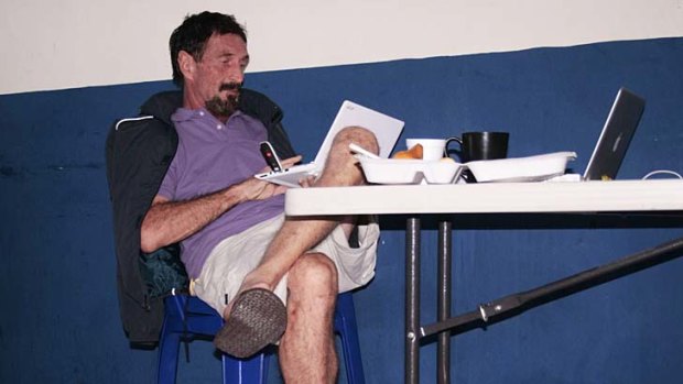 Caught on the run ... internet security pioneer John McAfee being interrogated by Interpol at police headquarters Guatemala City.