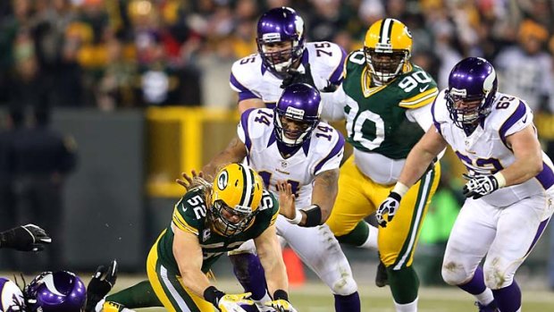Green Bay Packers linebacker Clay Matthews recovers a forced fumble in front of quarterback Joe Webb of the Minnesota Vikings.
