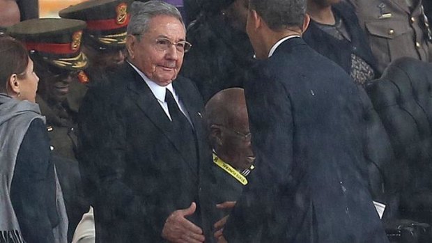 US President Barack Obama shakes hands with Cuban President Raul Castro at the FNB Stadium in Soweto, South Africa, for a memorial service for former South African President Nelson Mandela.