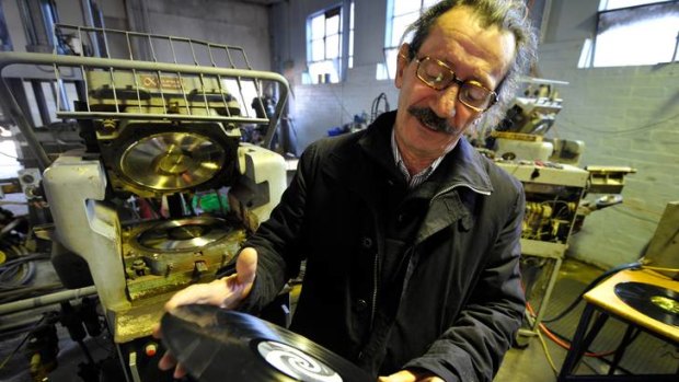 "Nothing romantic about it": Owner of Zenith Records, Chris Moss, inspects a 12-inch vinyl record that has just been pressed.