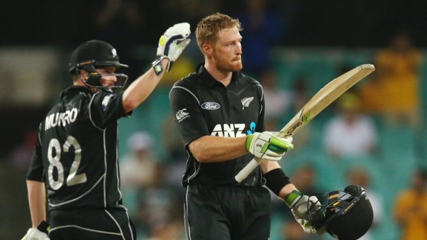 Lone hand: Martin Guptill salutes the crowd after reaching his century.