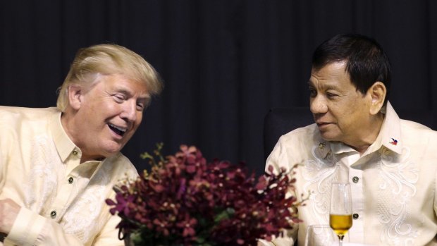 Donald Trump, left, talks with Philippine President Rodrigo Duterte during the gala dinner marking ASEAN's 50th anniversary.