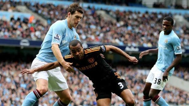 Chelsea's Ashley Cole tangles with Gareth Barry of Manchester City.