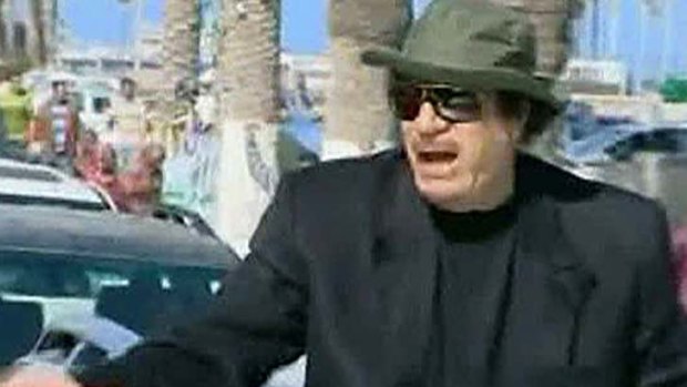 Libyan leader Muammar Gaddafi travels in a convoy through the streets of Tripoli in this still image taken from video on April 14, 2011.