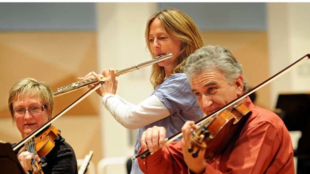 Melbourne Symphony Orchestra members Trevor Jones (viola), Wendy Clark (flute) and Lorraine Hook (violin) practice ABBA.