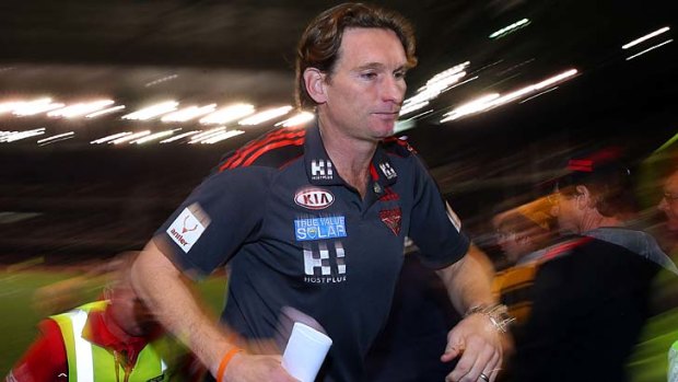 A grim-faced James Hird returns to the coaches' box after the three-quarter-time huddle.