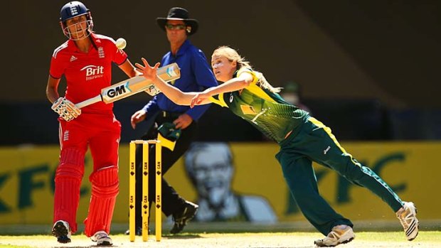 Ellyse Perry dives to field off her own bowling.