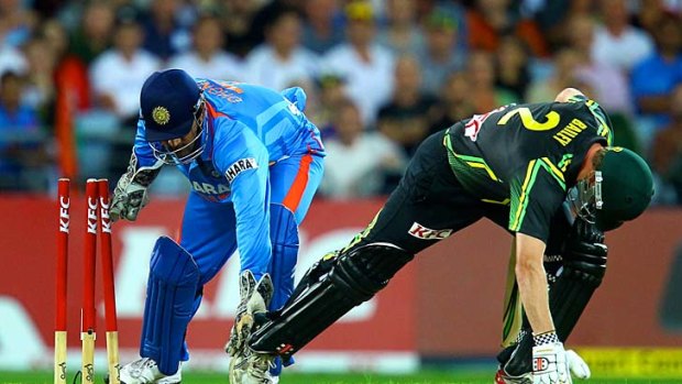 George Bailey avoids being stumped by his Indian counterpart, M.S. Dhoni.
