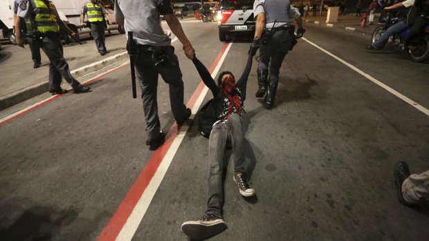 A demonstrator dragged away by police during protests in Sao Paulo in August, 2013.
