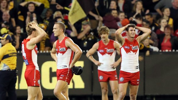 Disappointment: The Swans after their loss to the Tigers.