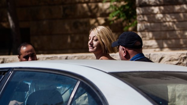 Tara Brown is escorted from court on Monday. 