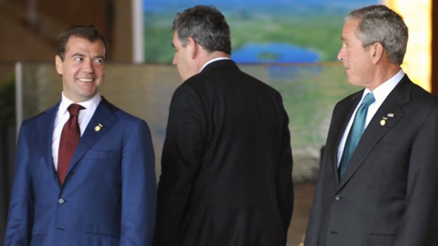 Dmitry Medvedev (left) exchanges pleasantries with George Bush, as Britain's Gordon Brown walks past.