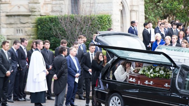 A mother's farewell: Kathy Kelly blows a kiss to her son Stuart Kelly's coffin.