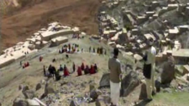 People search for survivors after a massive landslide buried a hundreds of homes in a village in Badakhshan province, northeastern Afghanistan.