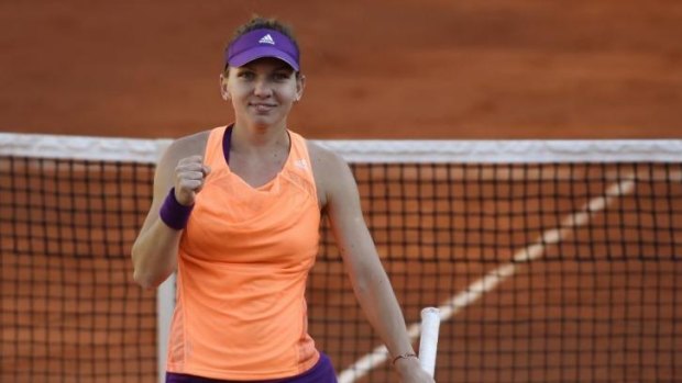 Simona Halep rejoices after defeating Andrea Petkovic to enter the French Open women's singles final.