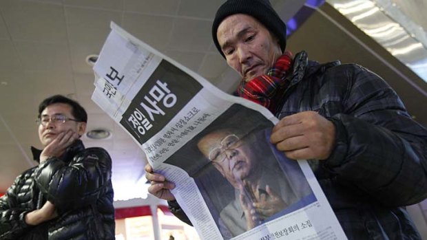 A South Korean man reads a local newspaper reporting the death of Kim Jong-il.