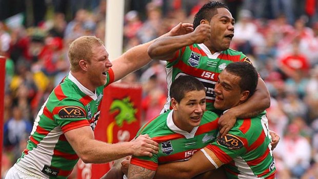 Michael Crocker, Nathan Peats and Chris Sandow of the Rabbitohs congratulate Dylan Farrell after he crashes over for a try.