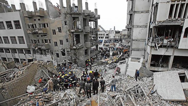 Rescuers search for survivors at the site of a bomb attack near the new Finance Ministry in Baghdad.