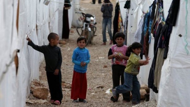 Syrian children outside their tents at a refugee camp in the city of Arsal, Lebanon.