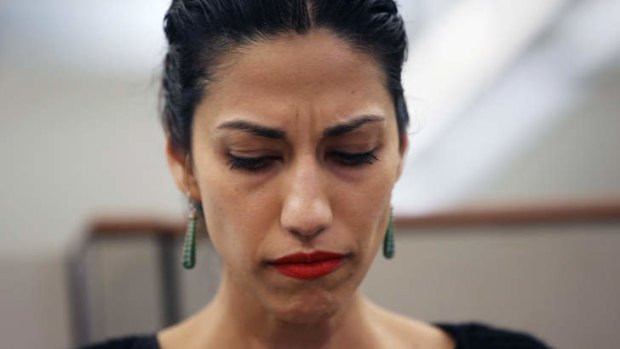 Huma Abedin, wife of Anthony Weiner, a leading candidate for New York City mayor, listens as her husband speaks at a press conference.