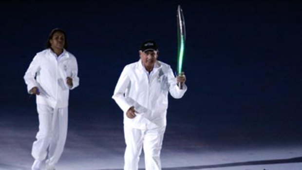 Gold Coast Mayor Ron Clarke carries the baton at the 2006 Commonwealth Games in Melbourne.