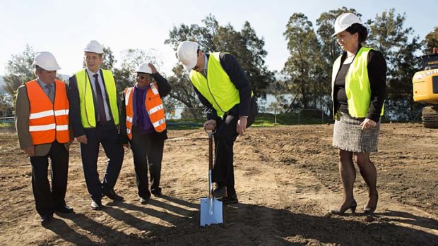 Digging in: Mike Kelly turns the first sof on Moruya's federally-funded $11.8 million aub-acute unit.