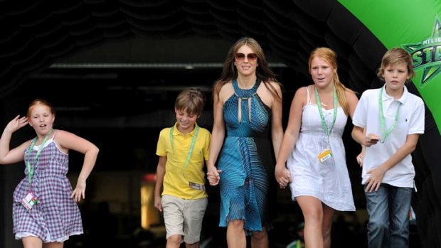 Go get them ... Elizabeth Hurley makes her way on to ground yesterday with Shane Warne's daughters Summer and brooke, and son Jackson, far right, and Hurley's son Damien, second from the left.