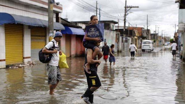 Residents   on a flooded street   in Sao Paulo, Brazil.