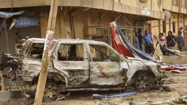 A car destroyed by an explosion that killed four people in a Christian neighbourhood of Kano on Monday. Boko Haram is also being blamed for the explosions in Jos.