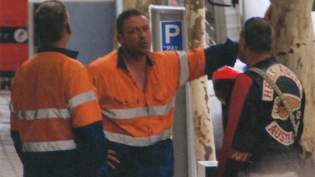 Building relations? Grocon safety managers Peter Hewett (left) and Daniel Van Camp talk to a Hells Angel bikie at the Brisbane building site in March.
