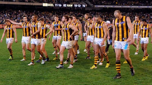 The Hawks leave the field after yet another loss to Geelong.