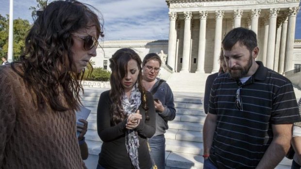 As the Supreme Court begins its new term this week, pro-life advocates hold a prayer vigil on the plaza of the high court in Washington, Saturday, Oct. 4, 2014. The group, Bound 4 Life, has come to the court for ten years to make a silent appeal against abortion.